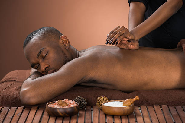 Young African Man Getting Massage In Spa